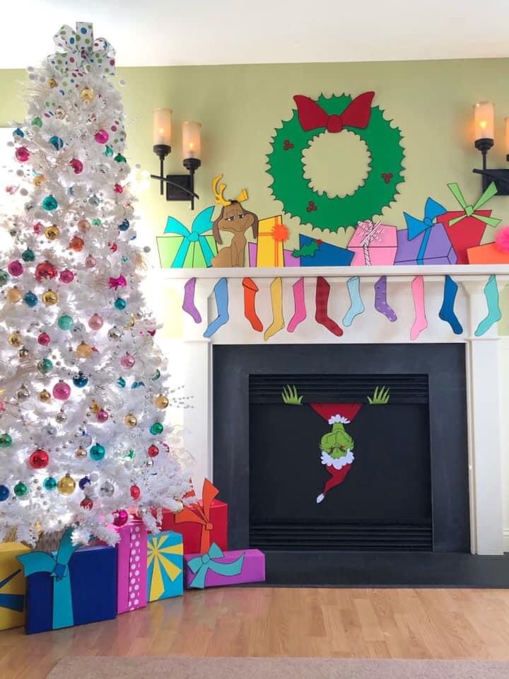 a decorated christmas tree sitting in front of a fireplace