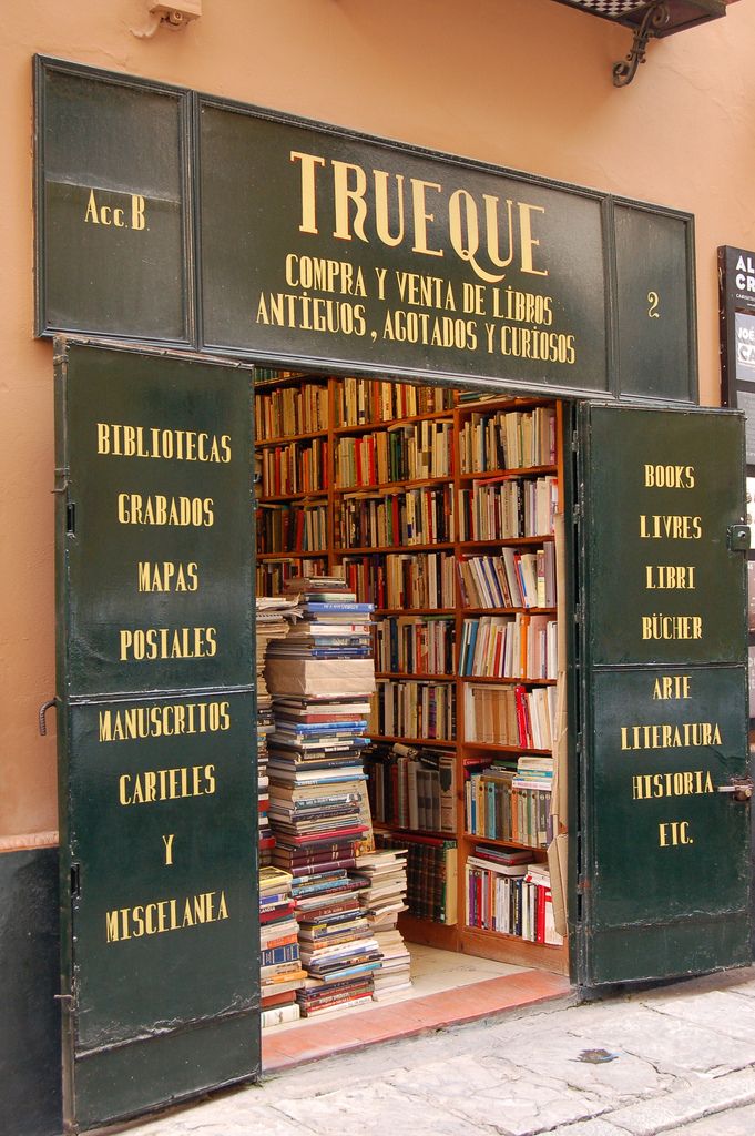 an open book store with lots of books on the front and shelves full of books