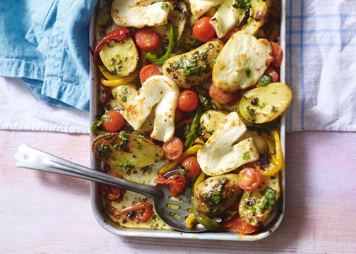 a casserole dish with potatoes, tomatoes and broccoli