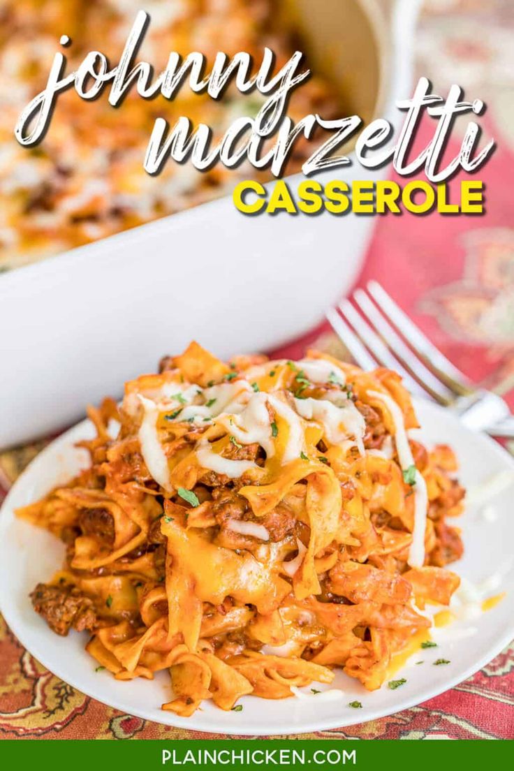 a white plate topped with pasta covered in cheese and sauce next to a casserole dish