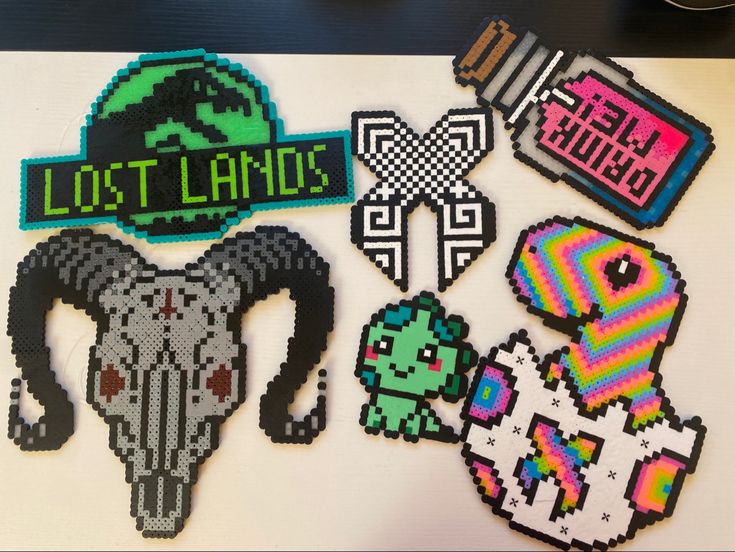 some pixelated stickers are laying on a white surface with the words lost lands