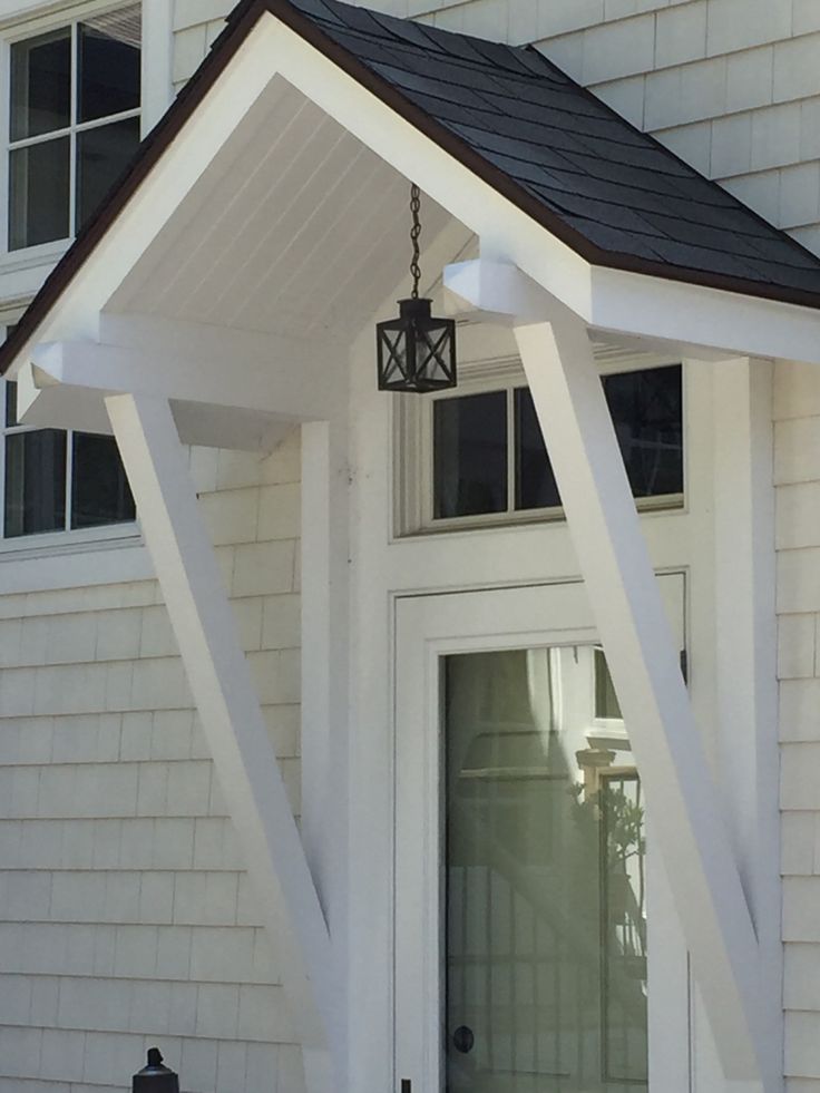 a white house with a black roof and door