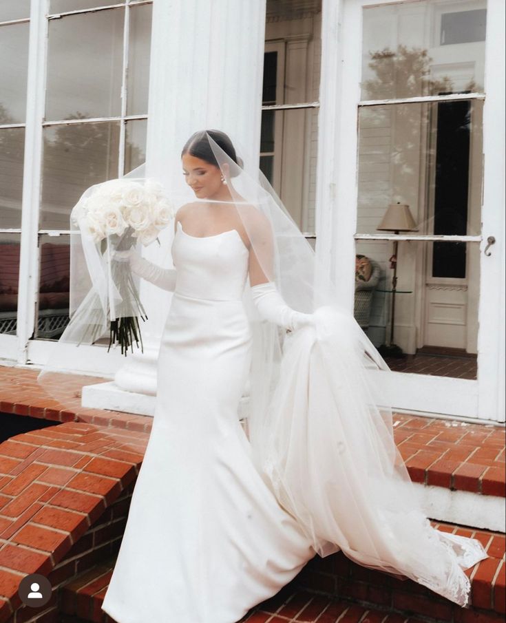 a woman in a wedding dress holding a bouquet