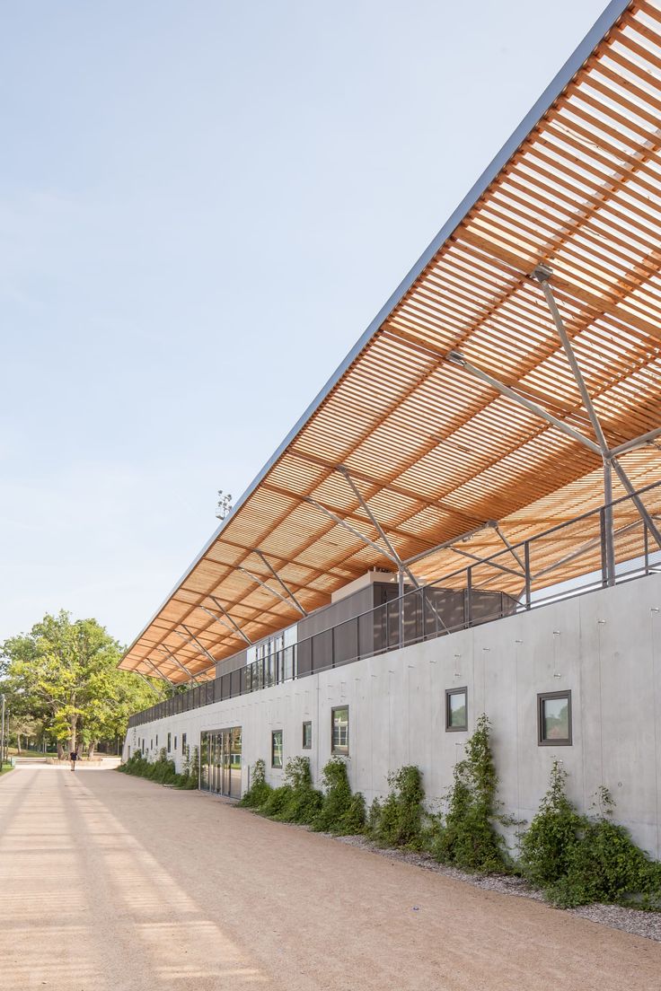 an empty parking lot next to a building with a canopy over the entrance and walkway