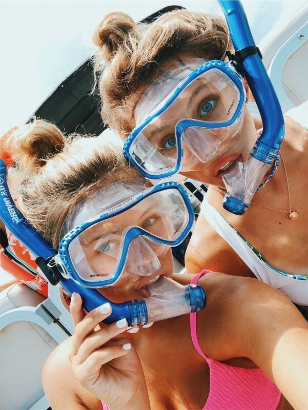 two girls wearing scuba gear and snorkels