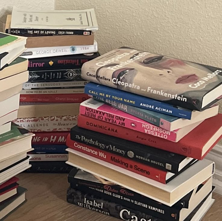 a stack of books sitting on top of a wooden floor