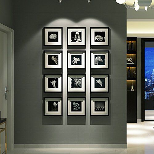 a living room with black and white pictures on the wall