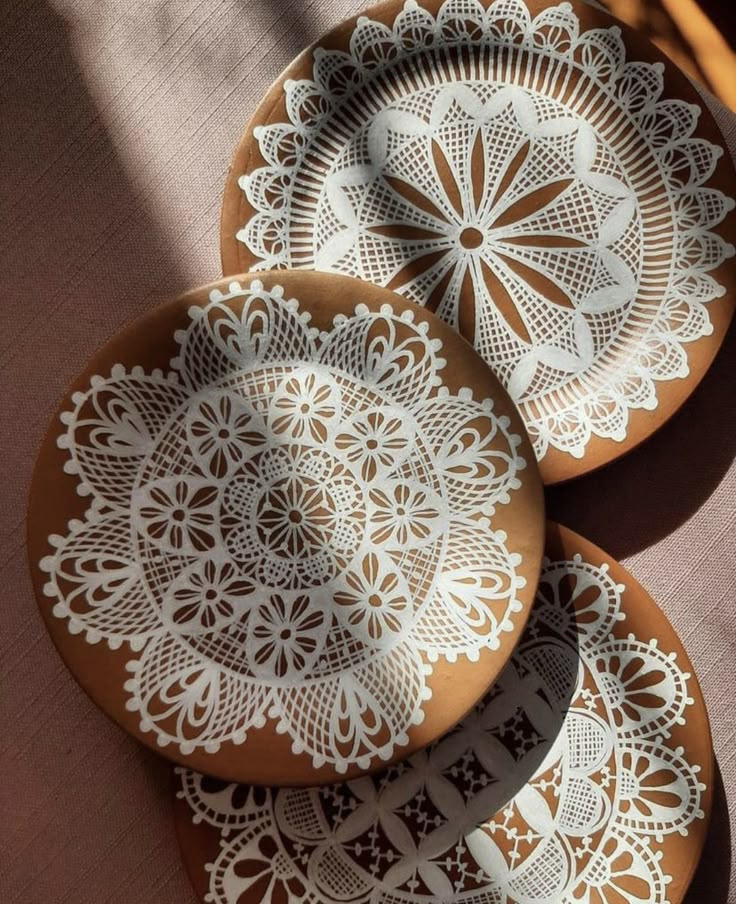 three brown and white plates sitting on top of a table