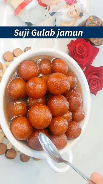 a bowl filled with food sitting on top of a table next to nuts and flowers