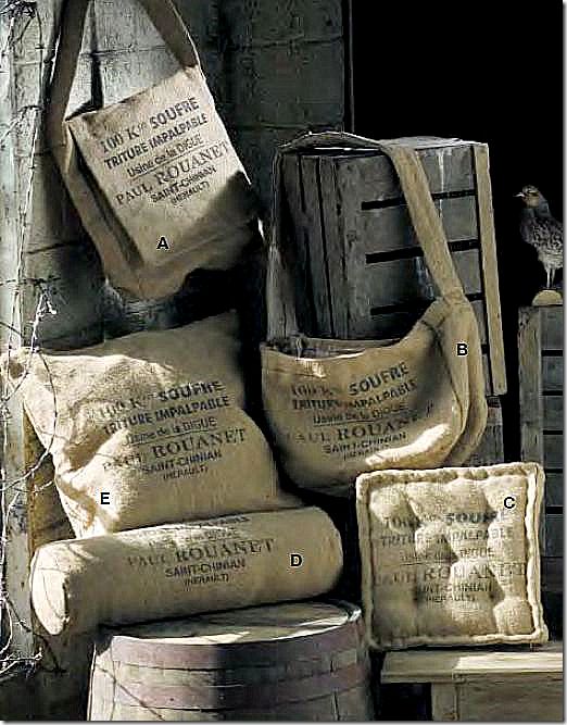 several bags stacked on top of each other next to wooden barrels and crates with birds perched on them