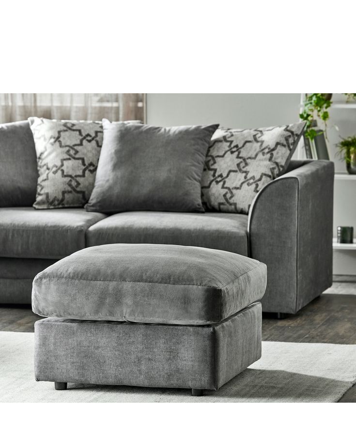 a living room with a gray couch and ottoman