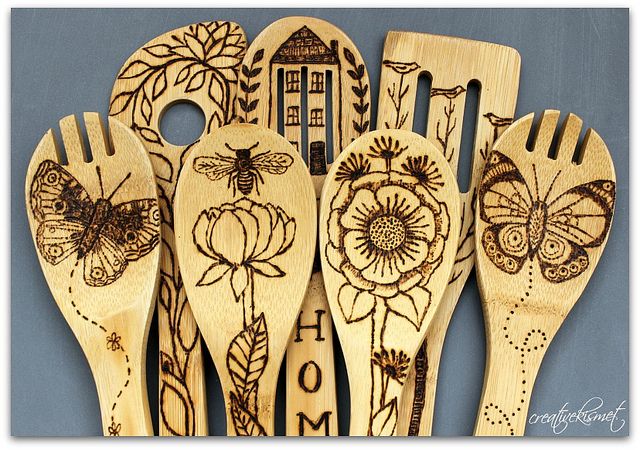 four wooden spoons with designs on them