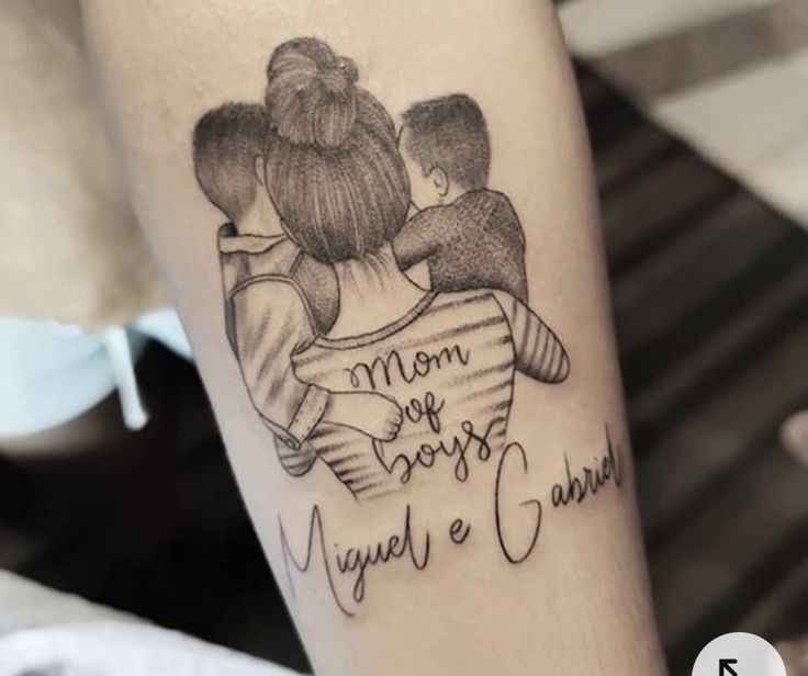 a woman with a tattoo on her arm that says mom and sons, angel and grandma