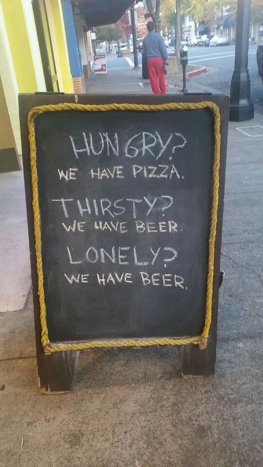 a chalkboard sign with writing on it that reads hungry we have pizza, thirsty we have beer, lonely we have beer