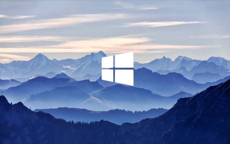 an image of the windows logo on top of a mountain with mountains in the background