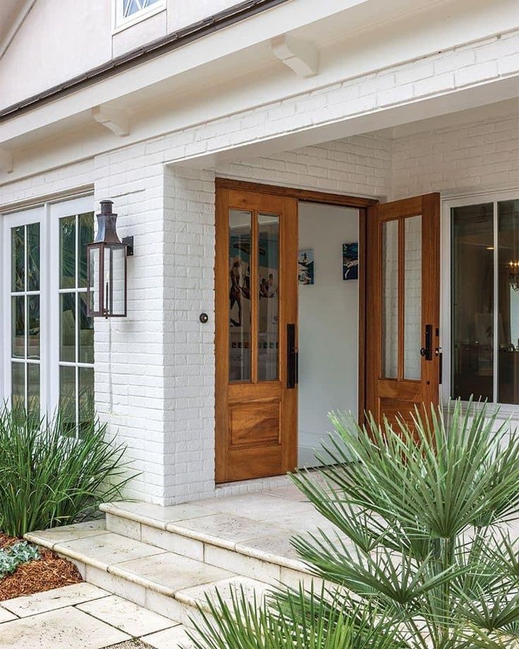 a white house with wooden doors and windows