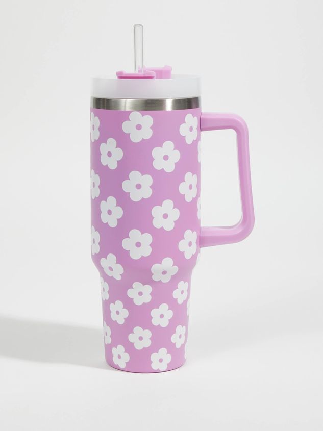 a pink coffee mug with white flowers on the front and sides, sitting against a white background