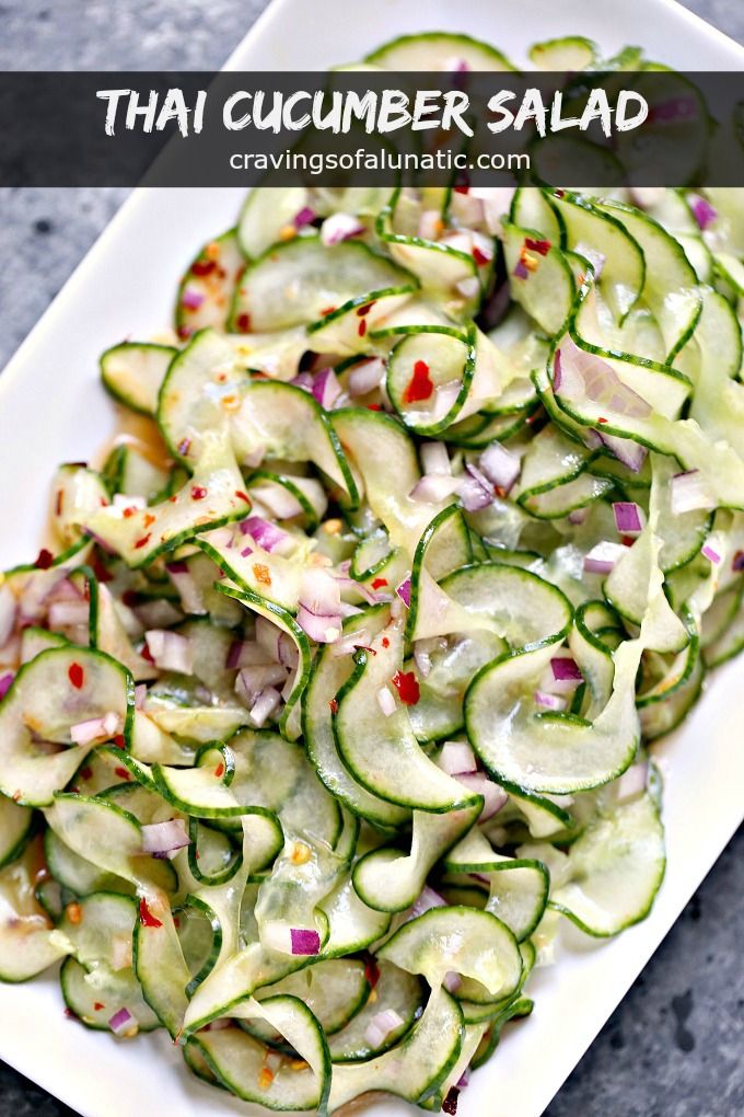 cucumber salad on a white plate with red onions