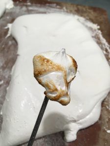 a marshmallow lollipop on a stick with icing