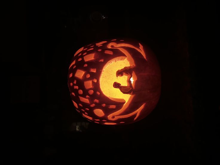 a carved pumpkin with the letter g on it