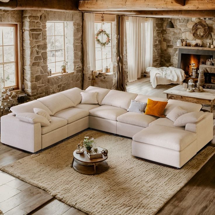 a living room filled with furniture and a fire place in the middle of the room