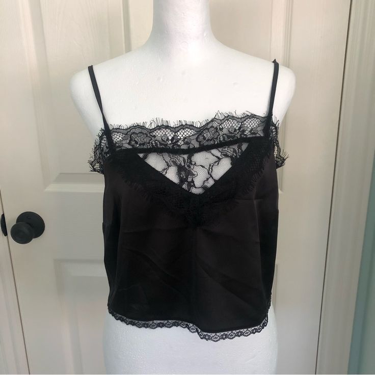 New With Tags Boutique Valera Black Lace Satin Cami Tank Top. High Lace On Front. Button Up On Back. Adjustable Straps Brand: Cellecci Chic Crop Top With Lace Trim For Night Out, Chic Lace Trim Crop Top For Night Out, Elegant Black Crop Top With Lace Trim, Elegant Black Lace Trim Crop Top, Black Sleeveless Crop Top With Lace Trim, Black Lace Trim Top For Night Out, Black Camisole Blouse For Night Out, Elegant Black Camisole Blouse, Chic Black Lace Top Crop Top