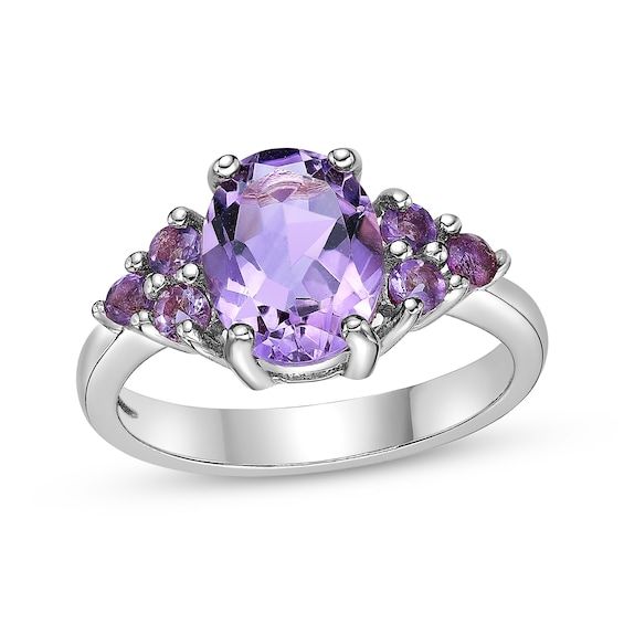 Dreamy hues and a dazzling design make this amethyst ring a wonderful gift for her birthday or anytime. Fashioned in sterling silver An oval-cut amethyst is the beautiful centerpiece Trios of round-cut amethysts cluster on the flanks for a bold look Oval Purple Amethyst Ring With Center Stone, Oval Amethyst Ring With Gemstone Accents In Sterling Silver, Oval Purple Amethyst Ring For Gift, Purple Oval Amethyst Ring Gift, Purple Amethyst Oval Ring For Gift, Purple Oval Amethyst Gift Ring, Oval Purple Amethyst Ring With Gemstone Accents, Purple Oval Birthstone Ring, Oval Purple Gemstones