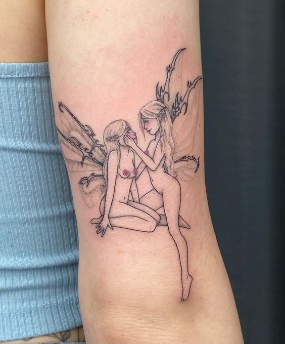 a couple of women sitting on top of each other in front of a tattoo design