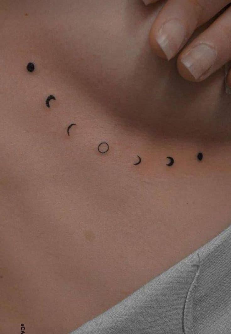 a woman's stomach with the word love written on it and small black dots