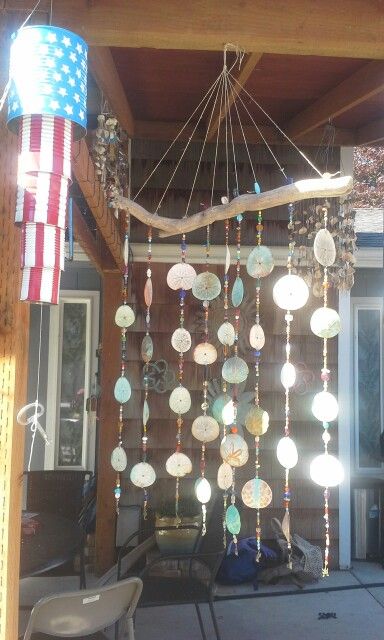 a wind chime hanging from the side of a wooden structure with an american flag on it