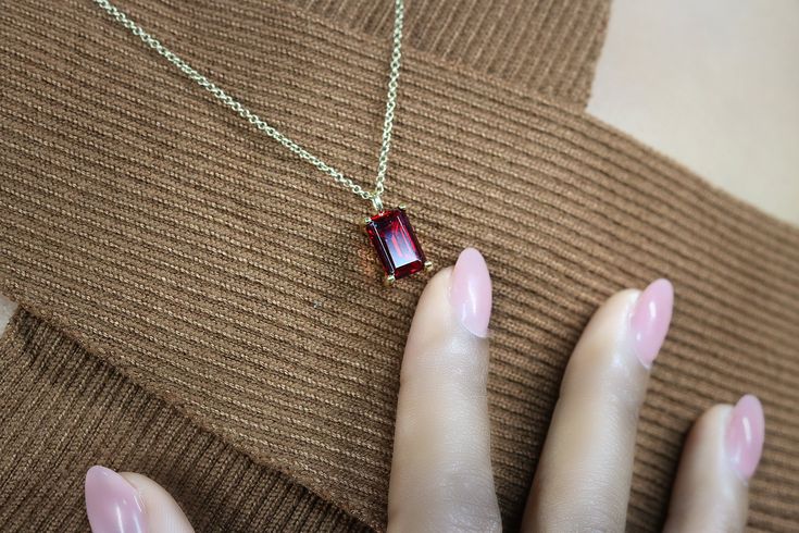 "Fall in love with the allure and elegance of this red stone necklace flaunting a Garnet pendant. This gemstone jewelry piece is a stunning piece to add to your ensemble. A classic Garnet necklace to add to your collection. ♥ Gemstone Type - Garnet (Lab Created) ♥ Gemstone Size - 7x11mm ♥ Gemstone Cut - Rectangle ♥ Metal Type (Main Photo) - 14k Gold Filled - Other options available in the drop down menu ♥ Length (Model Photo) - 45cm/18\" - Available from 14\" to 24\" (no additional cost) ❏ Why B Formal Necklace With Rectangular Gemstone Pendant, Formal Gemstone Necklace With Rectangular Pendant, Rectangular Gemstone Necklace For Wedding, Elegant Red Faceted Necklace, Fine Jewelry Ruby With Radiant Cut, Classic Red Radiant Cut Jewelry, Classic Radiant Cut Red Jewelry, Elegant Red Emerald-cut Jewelry, Fine Jewelry Garnet Rectangular