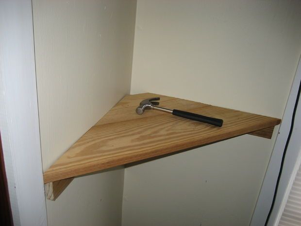 a wooden shelf with a wrench on it