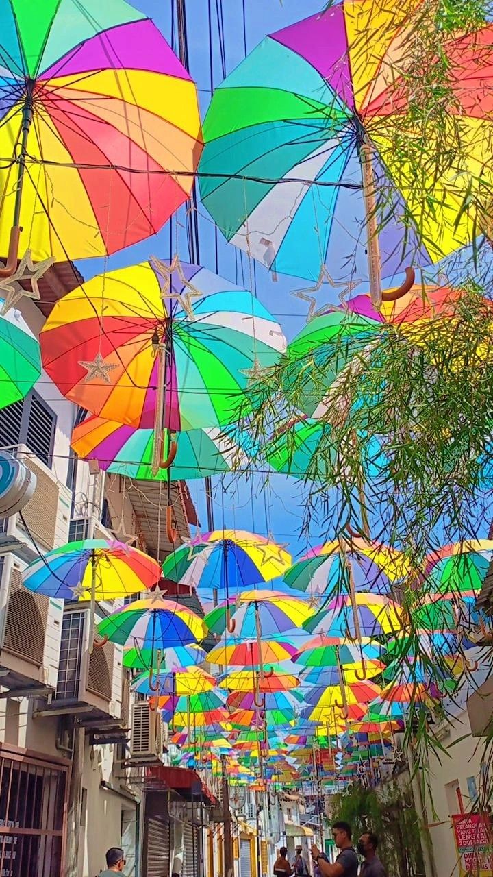 many colorful umbrellas are hanging from the ceiling