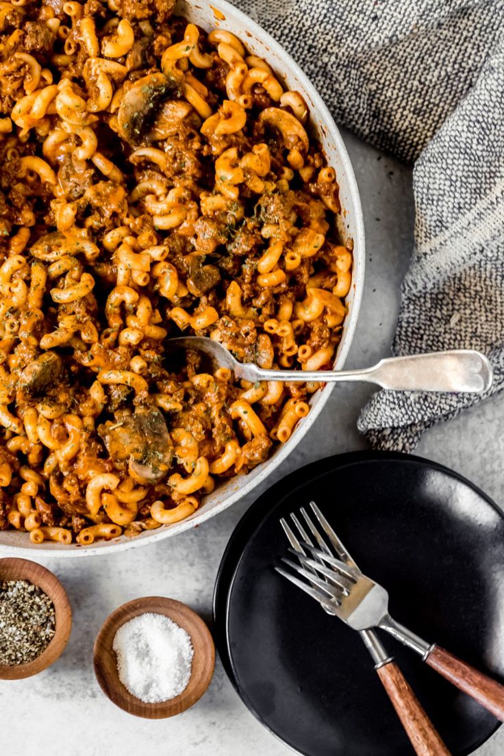 a bowl filled with macaroni and cheese next to other ingredients