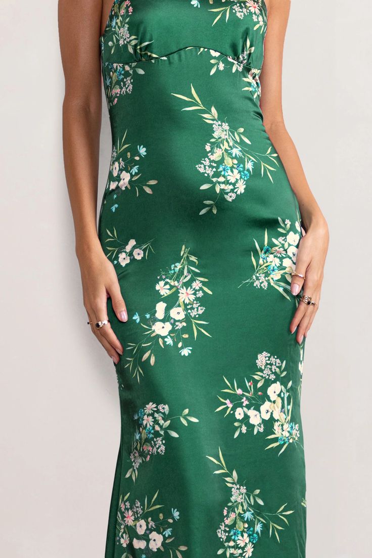 Look and feel utterly divine in our green floral print Grandeur halter neck maxi dress. Constructed in luxurious satin and with a cascading hemline, this stunning floor-sweeping gown is worthy of the red carpet. It's cut in a way that contours your curves beautifully – it cinches in at the waist and falls into an elegant fishtail shape, creating a gorgeous hourglass silhouette. This showstopping evening gown is essential for those special occasions. Red-carpet worthy!    Features  - Halter neckline  - Open back detail  - Floral print  - Premium satin fabric     Sizing & Fit   Model is 5’9 and wears UK size 8 / US size 4      Product Information      Slight stretch   Satin fabric (95% Polyester 5% Elastane)   Length from top of shoulder to hem: 157cm   SKU: CL126538