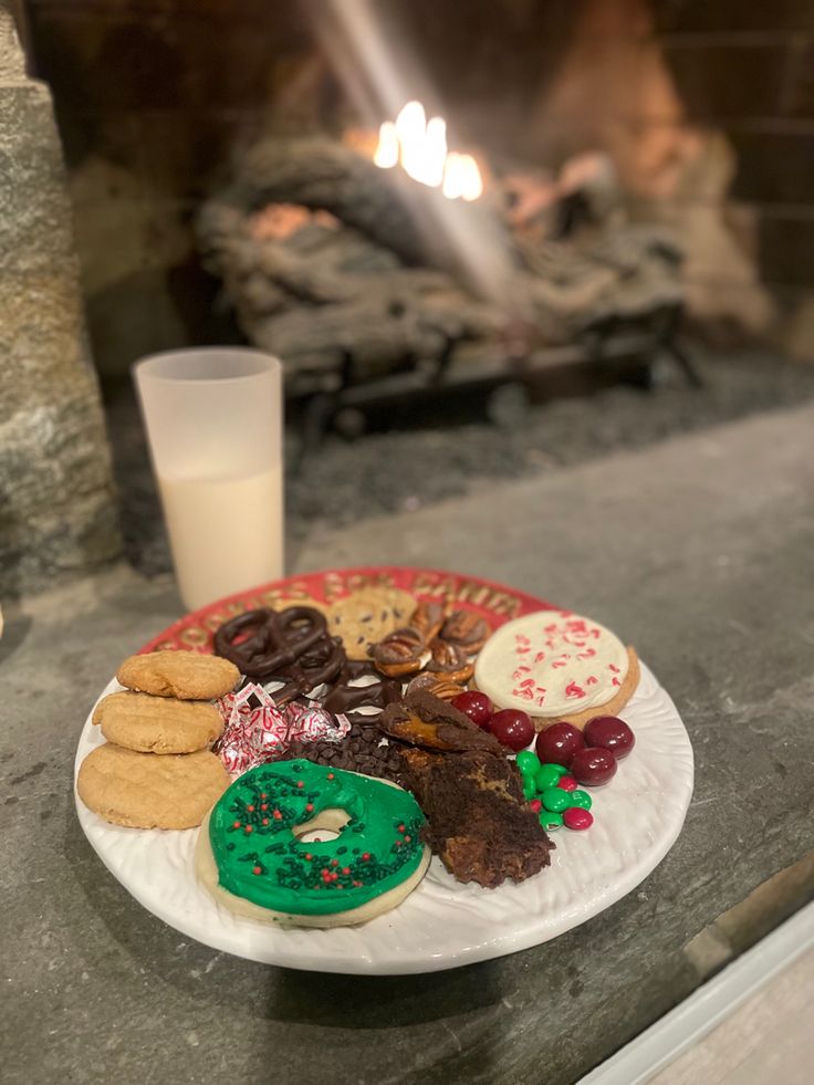 a white plate topped with lots of cookies and doughnuts