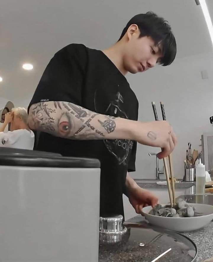 a young man preparing food in a kitchen