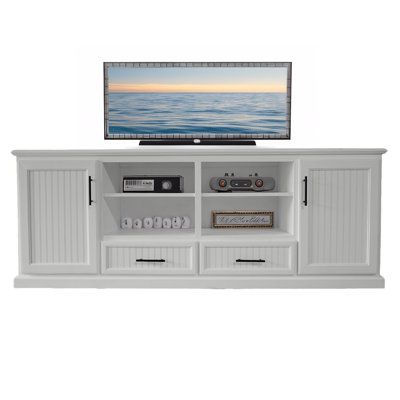 a flat screen tv sitting on top of a white entertainment center