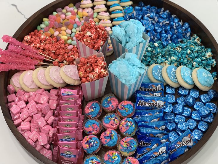 a platter filled with lots of different flavored treats and candy bars on top of each other