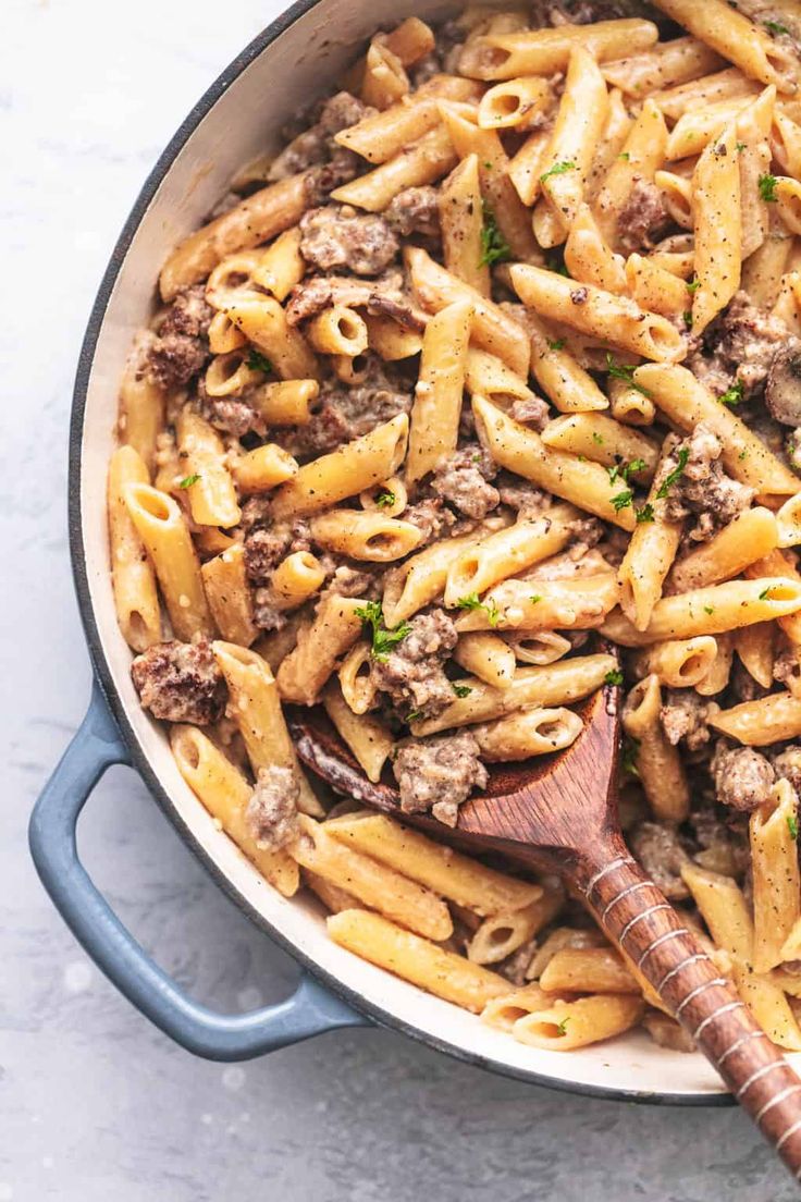 a skillet filled with pasta and meat