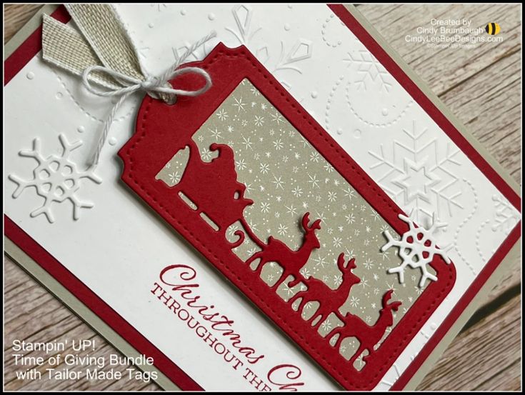 a close up of a christmas card with snowflakes and reindeers on it