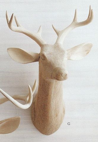 a wooden deer head with antlers on it