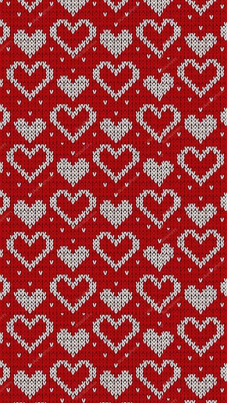 a red and white knitted pattern with hearts on the front, in two rows