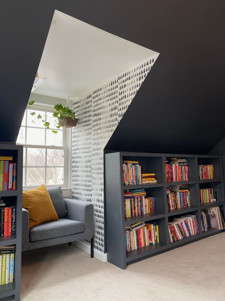 a living room with bookshelves and a couch in front of a window filled with books