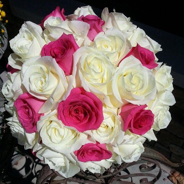 a bouquet of white and pink roses on a table