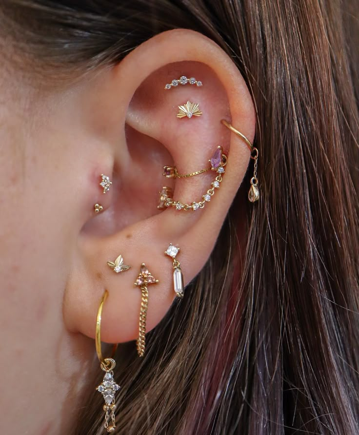 a close up of a person's ear with three different types of piercings