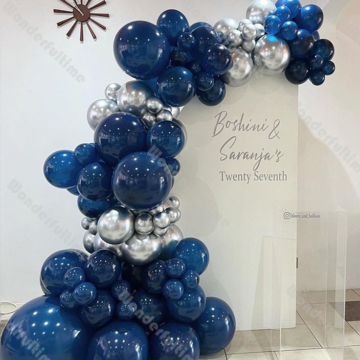 blue and silver balloons in the shape of an arch