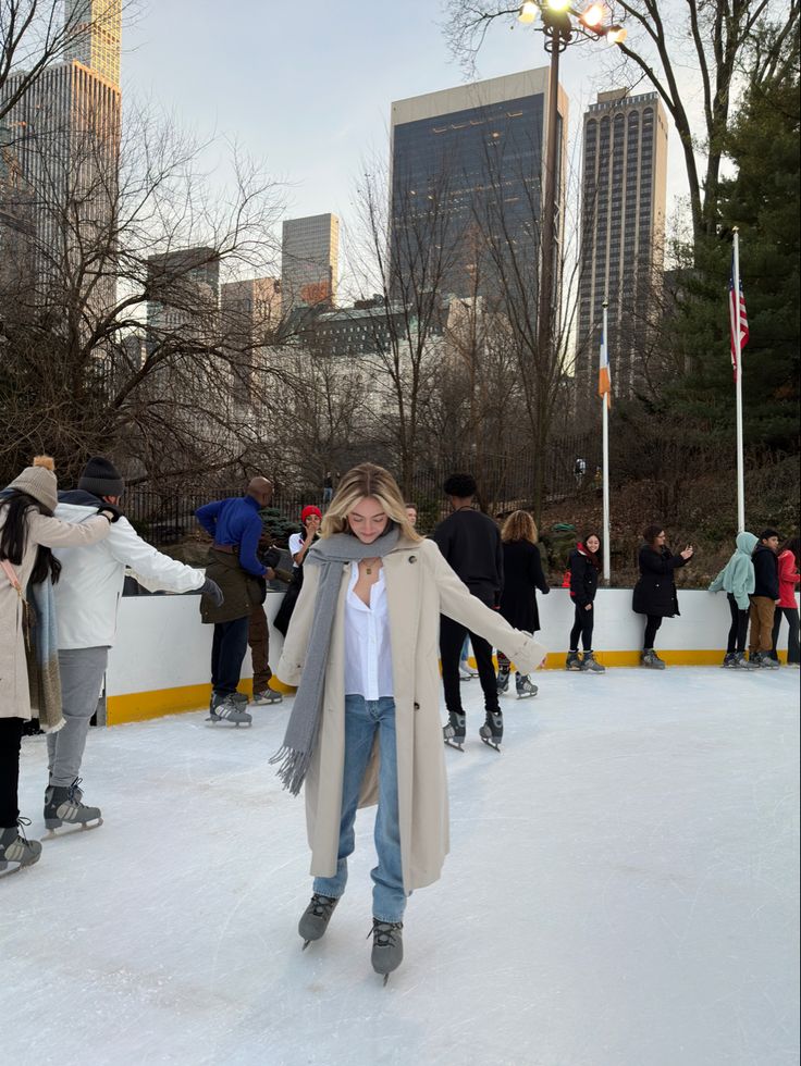 a woman standing on top of an ice rink