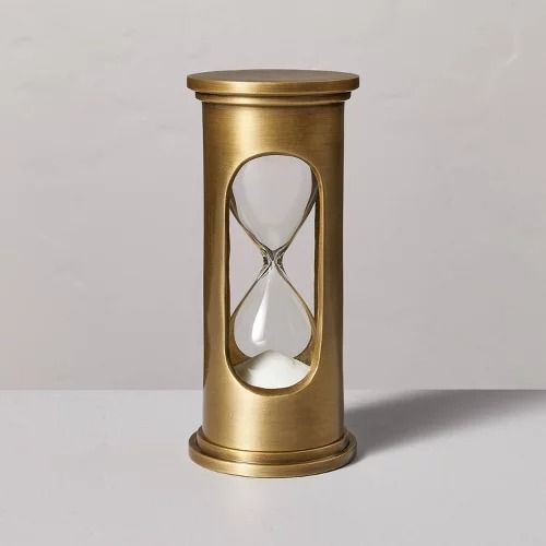 an hourglass is sitting on a white surface