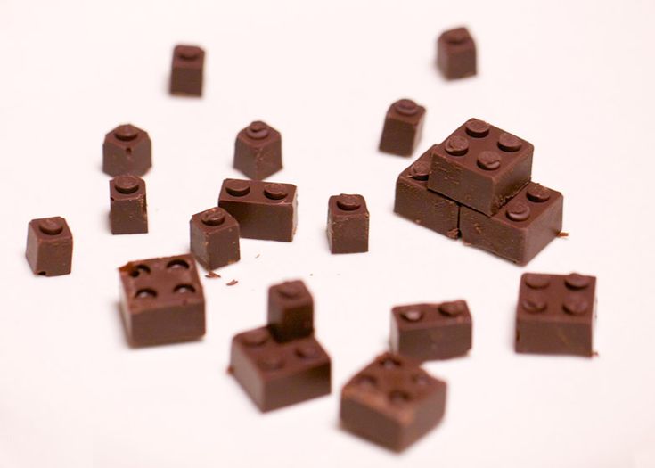 several pieces of chocolate are arranged in the shape of cubes on a white surface